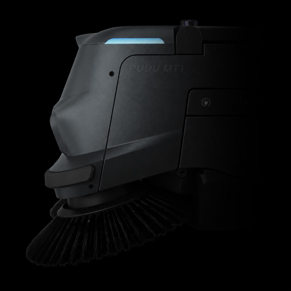 PUDU MT1 — perfil lateral com escova de varrição e design minimalista